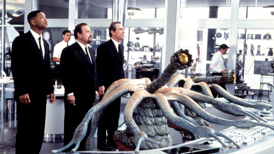 Will Smith, Rip Torn and Tommy Lee Jones confront a mysterious alien in “Men in Black.” - Credit: ©Columbia Pictures/Courtesy Eve