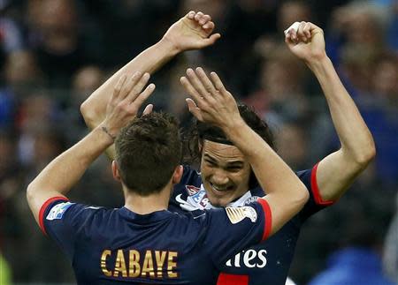 Paris St Germain's Edinson Cavani (R) celebrates with team mate Yohan Cabaye after defeating Olympique Lyon in the French League Cup final soccer match at the Stade de France stadium in Saint-Denis, near Paris, April 19, 2014. REUTERS/Benoit Tessier