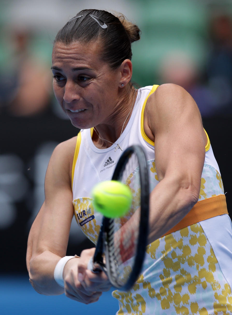 Flavia Pennetta of Italy makes a backhand return to Li Na of China during their quarterfinal at the Australian Open tennis championship in Melbourne, Australia, Tuesday, Jan. 21, 2014.(AP Photo/Aaron Favila)