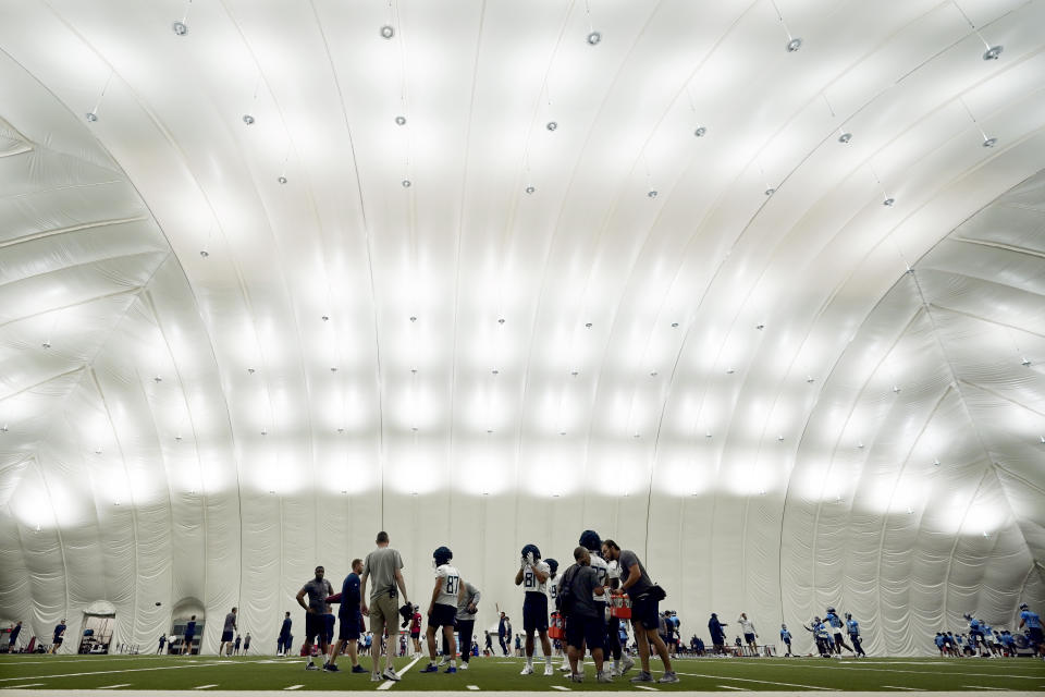 Tennessee Titans players practice in their indoor facility because of rain during training camp at the NFL football team's practice facility Friday, July 29, 2022, in Nashville, Tenn. (AP Photo/Mark Humphrey)