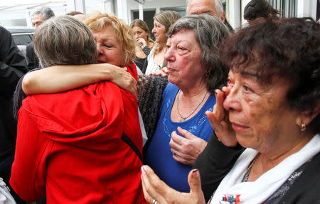 Relatives of former workers at Ford Motor Co. local plant and ex-political prisoners react after two former Ford executives were convicted during the trail, in Buenos Aires, Argentina, December 11, 2018. REUTERS/Bernardino Avila