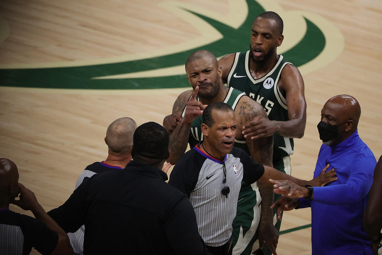 MILWAUKEE, WISCONSIN - JUNE 10: P.J. Tucker #17 of the Milwaukee Bucks is held back by Khris Middleton #22 during an altercation with Kevin Durant #7 of the Brooklyn Nets in the second half of Game Three of the Eastern Conference second round playoff series at the Fiserv Forum on June 10, 2021 in Milwaukee, Wisconsin. NOTE TO USER: User expressly acknowledges and agrees that, by downloading and or using this photograph, User is consenting to the terms and conditions of the Getty Images License Agreement. (Photo by Stacy Revere/Getty Images)