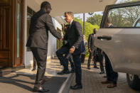 Secretary of State Antony Blinken, center, is greeted by Rwanda's Minister of Foreign Affairs Vincent Biruta, left, as he arrives to meet with Rwandan President Paul Kagame at the President's Office in Urugwiro Village in Kigali, Rwanda, Thursday, Aug. 11, 2022. Blinken is on a ten day trip to Cambodia, Philippines, South Africa, Congo, and Rwanda. (AP Photo/Andrew Harnik, Pool)