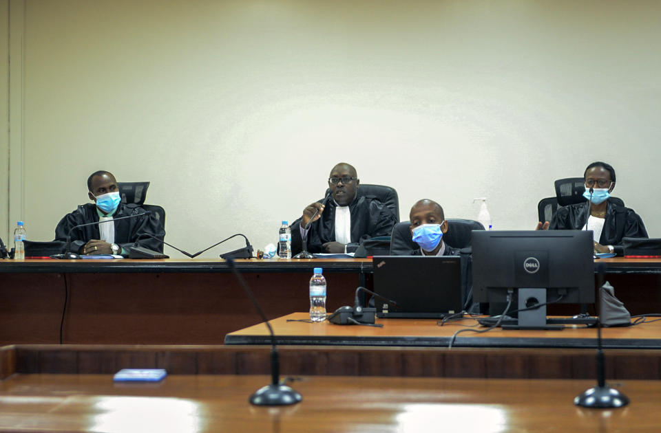 Judges Antoine Muhima, center, Beatrice Mukamurenzi, right, and Eugene Ndagijimana, left, deliver the ruling in the case of Paul Rusesabagina at a court in Kigali, Rwanda Monday, Sept. 20, 2021. The man who inspired the film "Hotel Rwanda" has been convicted of terrorism offenses and sentenced to 25 years in prison in a trial that human rights watchdogs and other critics of Rwanda's repressive government have described as an act of retaliation. (AP Photo/Muhizi Olivier)