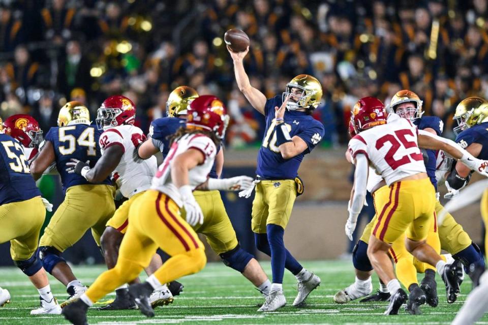 Oct 14, 2023; South Bend, Indiana, USA; Notre Dame Fighting Irish quarterback Sam Hartman (10) throws for a touchdown in the third quarter against the USC Trojans at Notre Dame Stadium.