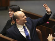 Israel's designated new prime minister Naftali Bennett sends greetings during a Knesset session in Jerusalem Sunday, June 13, 2021. Bennett is expected later Sunday to be sworn in as the country's new prime minister, ending Prime Minister Benjamin Netanyahu's 12-year rule. (AP Photo/Ariel Schali22