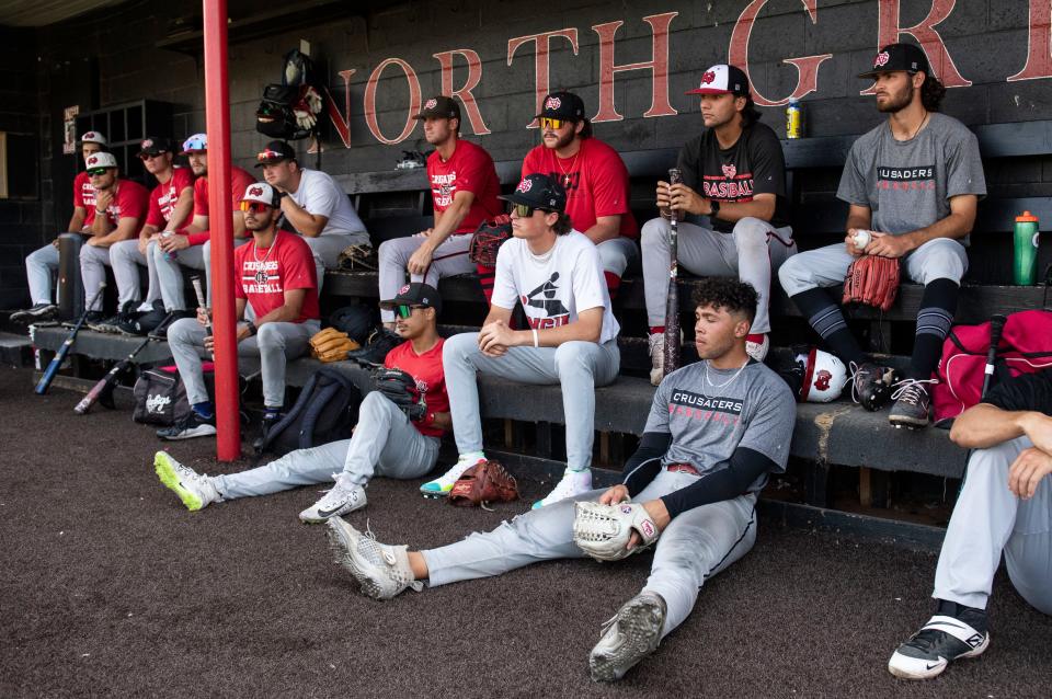 North Greenville baseball players listen to their coach in the dugout before practice, in Travelers Rest, Wednesday, June 2, 2022. 