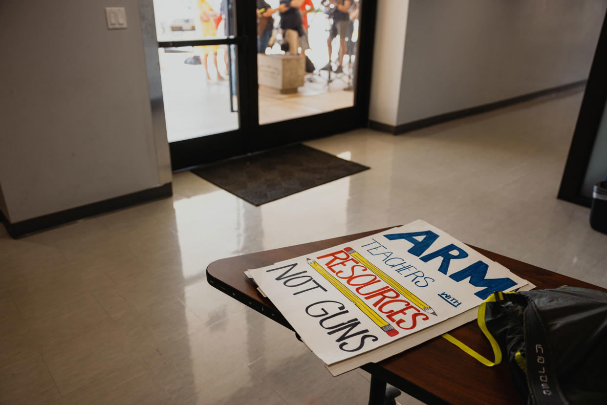 A sign at the AFLCIO office before demonstrators with the Texas American Federation of Teachers prepare to march, reading “Arm teachers with resources not guns”
