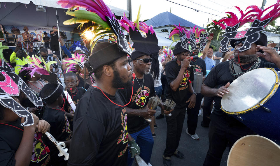 In this photo provided by the Florida Keys News Bureau, Junkanoo dancers jam on Petronia Street Friday, Oct. 20, 2023, in Key West, Fla., during the Goombay Festival that marks the beginning of Fantasy Fest, the subtropical island's annual costuming and masking festival. A 10-day schedule of masquerades, elaborate parties and costume competitions continues through Sunday, Oct. 29. The festival is themed "Uniforms and Unicorns … 200 Years of Sailing into Fantasy" to salute the Florida Keys' 2023 bicentennial and that of the U.S. Navy's presence in Key West. (Rob O'Neal/Florida Keys News Bureau via AP)