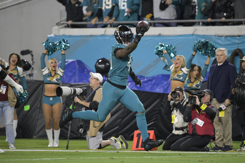 Jacksonville Jaguars linebacker Josh Allen (41) returns a fumble for a touchdown in the second half of an NFL football game against the Tennessee Titans, Saturday, Jan. 7, 2023, in Jacksonville, Fla. (AP Photo/Phelan M. Ebenhack)