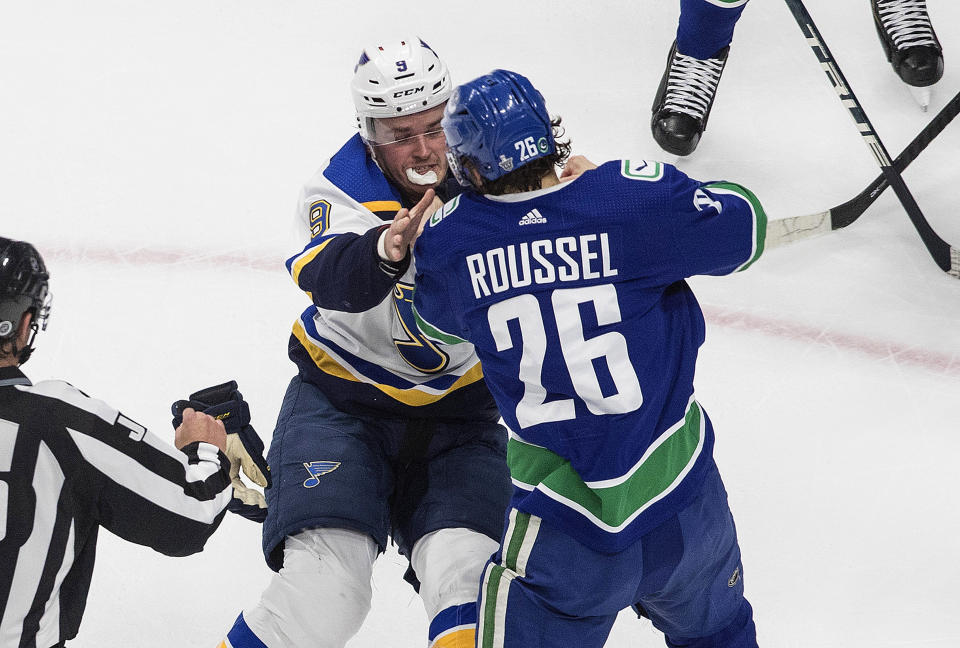 Vancouver Canucks' Antoine Roussel (26) and St. Louis Blues' Sammy Blais (9) fight during the first period of an NHL Western Conference Stanley Cup playoff game in Edmonton, Alberta, Monday, Aug. 17, 2020. (Jason Franson/The Canadian Press via AP)