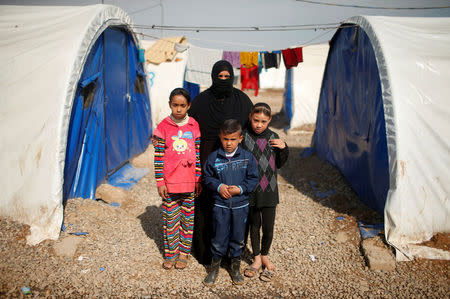 Displaced Iraqi Orouba Abdelhamid, 31, poses for a photograph with her children at Hammam al-Alil camp south of Mosul, Iraq, April 1, 2017. Abdelhamid's husband, an engineer, got killed in a rocket strike as government forces arrived to expel Islamic State from her home city Mosul. "No one is left for me over there so I came here... I cannot return to the house," she said. REUTERS/Suhaib Salem SEARCH "DISPLACED REFUGE" FOR THIS STORY. SEARCH "WIDER IMAGE" FOR ALL STORIES.