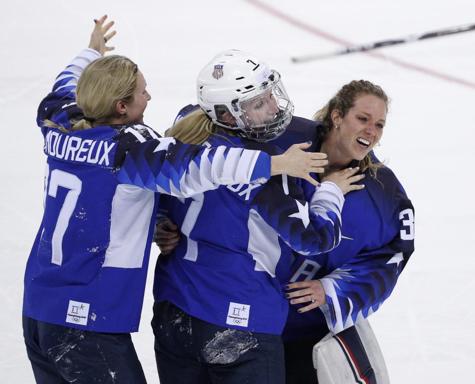 Jocelyne Lamoureux-Davidson (left), sister Monique Lamoureux-Morando (center) and backup goaltender Alex Rigsby celebrate after winning the gold medal. (Reuters)