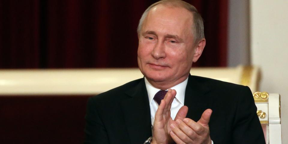 Russian President Vladimir Putin clapping.