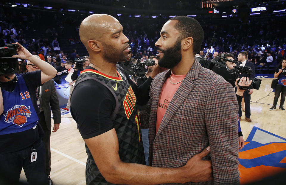 Atlanta Hawks guard Vince Carter (15) embraces injured New York Knicks player Wayne Ellington after an NBA basketball game in New York, Tuesday, Dec. 17, 2019, at what is likely Carter's last appearance at Madison Square Garden as an active player. The Knicks defeated the Hawks 143-120. (AP Photo/Kathy Willens)