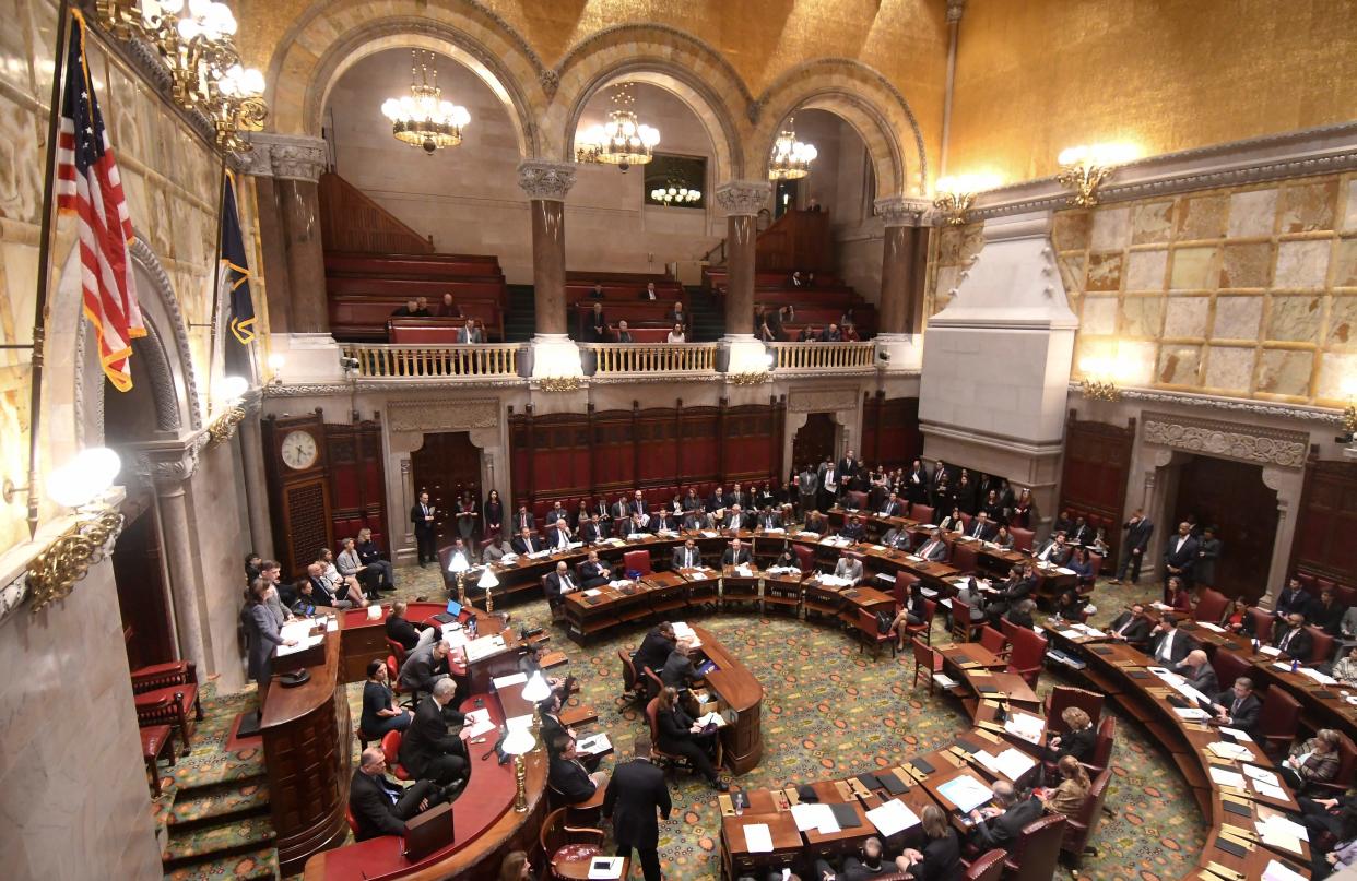 Members of the New York Senate vote for the Child Victims Act in the Senate Chamber at the state Capitol on Monday, Jan. 28, 2019, in Albany, N.Y.