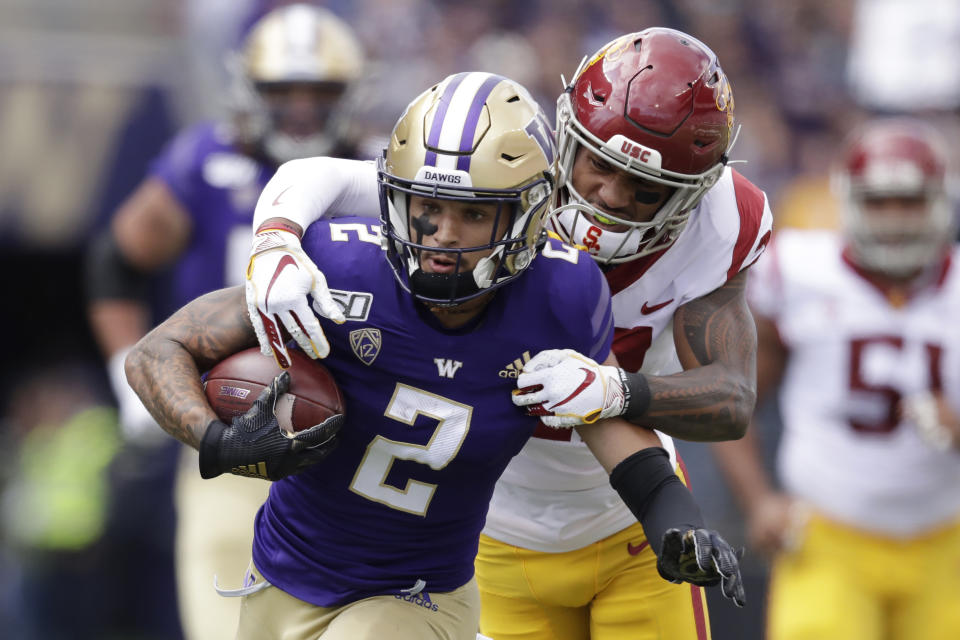 Southern Cal's Isaiah Pola-Mao reaches to tackle Washington's Aaron Fuller (2) in the first half of an NCAA college football game Saturday, Sept. 28, 2019, in Seattle. (AP Photo/Elaine Thompson)