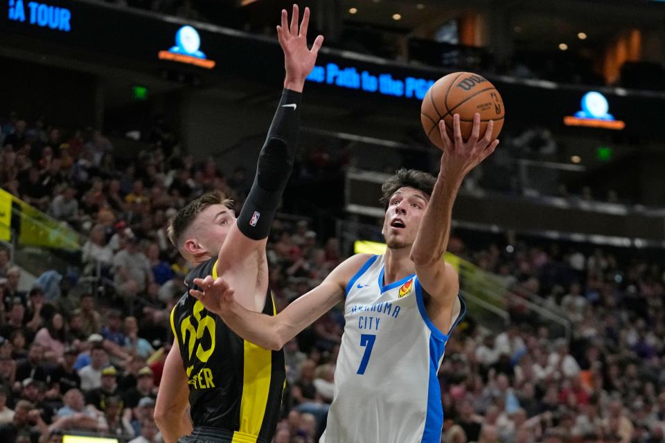 Thunder forward Chet Holmgren (7) goes to the basket as Utah's Micah Potter (25) defends in the first half during an NBA Summer League game July 3 in Salt Lake City.