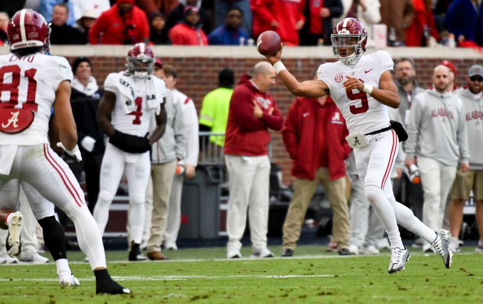 Alabama quarterback Bryce Young scrambles and completes a pass to Cameron Latu to convert a third down.