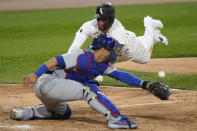 Chicago White Sox's Yoan Moncada scores on a three-run double by Jose Abreu as Chicago Cubs catcher Willson Contreras misses the throw during the fourth inning of a baseball game in Chicago, Saturday, Sept. 26, 2020. (AP Photo/Nam Y. Huh)