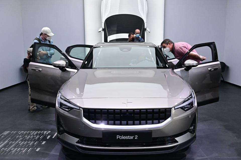 Visitors discovar a Polestar 2 car at the International Motor Show (IAA) in Munich, southern Germany, on September 10, 2021. - Germany's revamped IAA auto show, one of the world's largest, is celebrating all things car-related, but climate concerns and pandemic woes threaten to spoil the party. (Photo by Tobias Schwarz / AFP) (Photo by TOBIAS SCHWARZ/AFP via Getty Images)