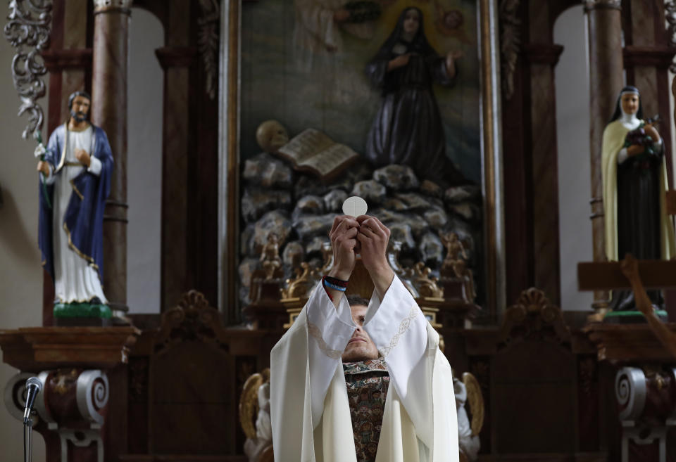 Roman Catholic priest Michal Lajcha serves a mass in a church in Klak, Slovakia, Monday, Sept. 17, 2018. Lajcha is challenging the Roman Catholic Church’s celibacy rules in a rare instance of dissent in the conservative religious stronghold in central and eastern Europe. (AP Photo/Petr David Josek)