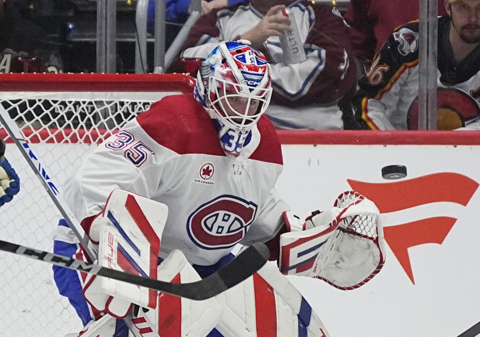 Montreal Canadiens goaltender Sam Montembeault deflects puck in the second period of an NHL hockey game against the Colorado Avalanche Tuesday, March 26, 2024, in Denver. (AP Photo/David Zalubowski)
