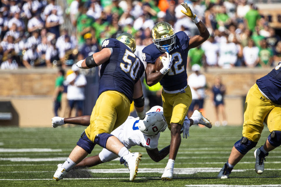 Notre Dame's Jeremiyah Love (12) gets past Tennessee State's Bryce Phillips (0) as Rocco Spindler (50) blocks during the first half of an NCAA college football game on Saturday, Sept. 2, 2023 in South Bend, Ind. (AP Photo/Michael Caterina)