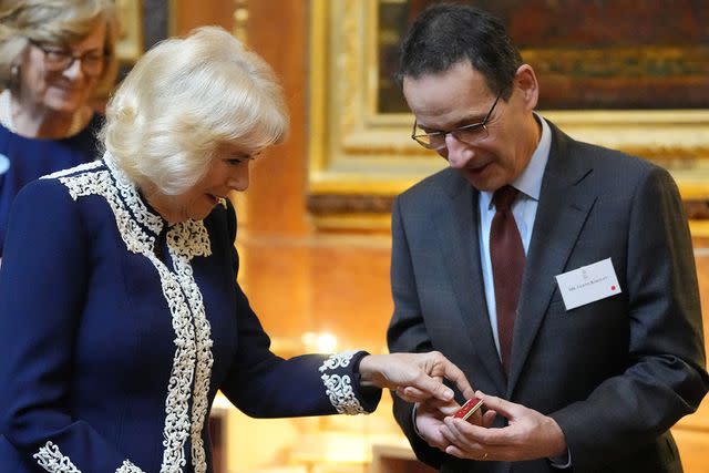 <p>KIRSTY WIGGLESWORTH/POOL/AFP via Getty Images</p> Queen Camilla at the Windsor Castle reception for the new Miniature Library collection on Jan. 30.