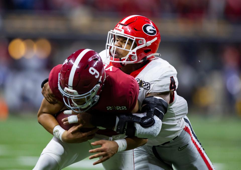 Georgia linebacker Nolan Smith tackles Alabama quarterback Bryce Young during the national championship game.