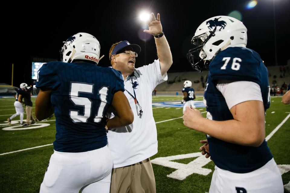 Roosevelt head coach Erik Link congratulates his players after a game Oct. 20, 2017, in Des Moines, Iowa. Link now coaches at Missouri.