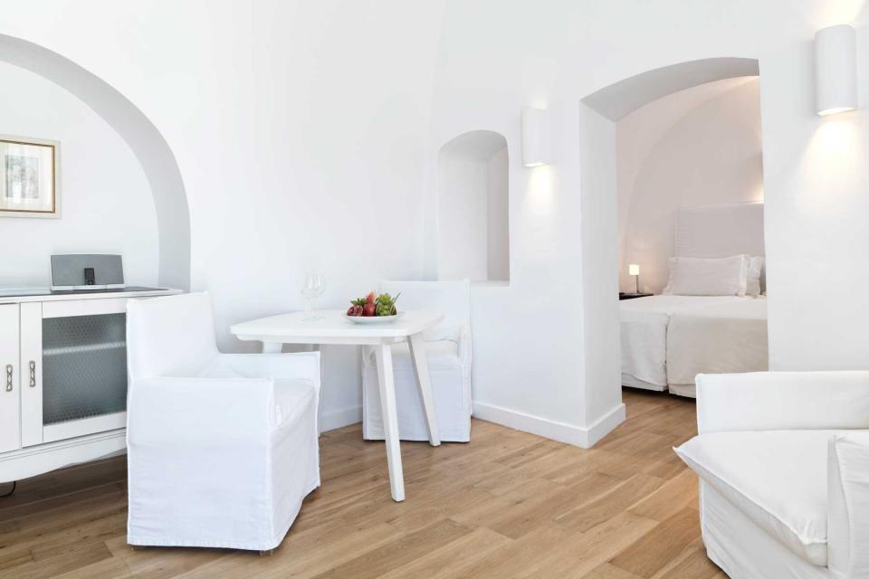 All white guest room at the Katikies Hotel in Santorini, Greece