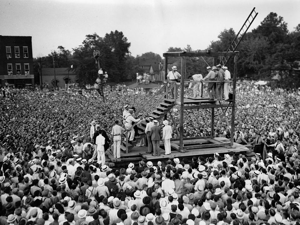 Rainey Bethea walks up the stairs with guards for his public execution, in this Aug. 14, 1936 photo in Owensboro, KY.