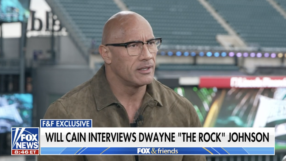 Dwayne "The Rock" Johnson in a brown shirt, interviewed on "FOX & Friends."