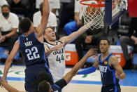 Utah Jazz forward Bojan Bogdanovic (44) goes to the basket between Oklahoma City Thunder center Isaiah Roby (22) and forward Darius Bazley, right, in the first half of an NBA basketball game Friday, May 14, 2021, in Oklahoma City. (AP Photo/Sue Ogrocki)