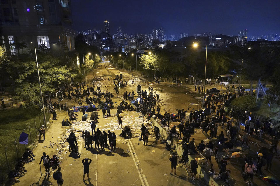 Students use bricks and obstacles to block a main road at the City University campus in Hong Kong, Tuesday, Nov. 12, 2019. Police and protesters battled outside university campuses and several thousand demonstrators blocked roads as they took over a central business district at lunchtime on Tuesday in another day of protest in Hong Kong. (AP Photo/Vincent Yu)