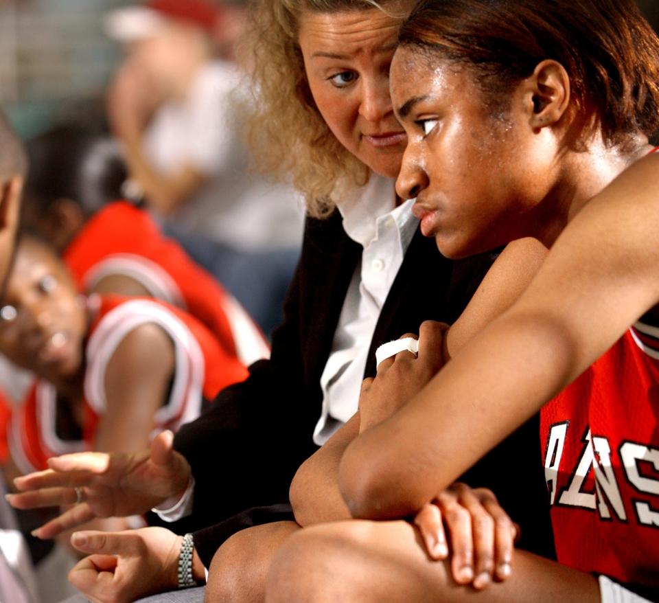 Seventy-First coach Tracie Taylor talks to LaToya Pringle during the Falcons' win against Broughton in the regional, March 8, 2003.