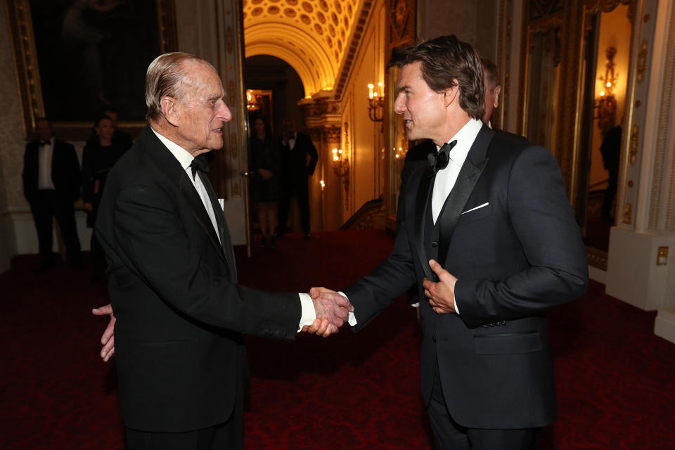 The Duke of Edinburgh meets Tom Cruise during a dinner at Buckingham Palace in London to mark the 75th anniversary of the Outward Bound Trust.