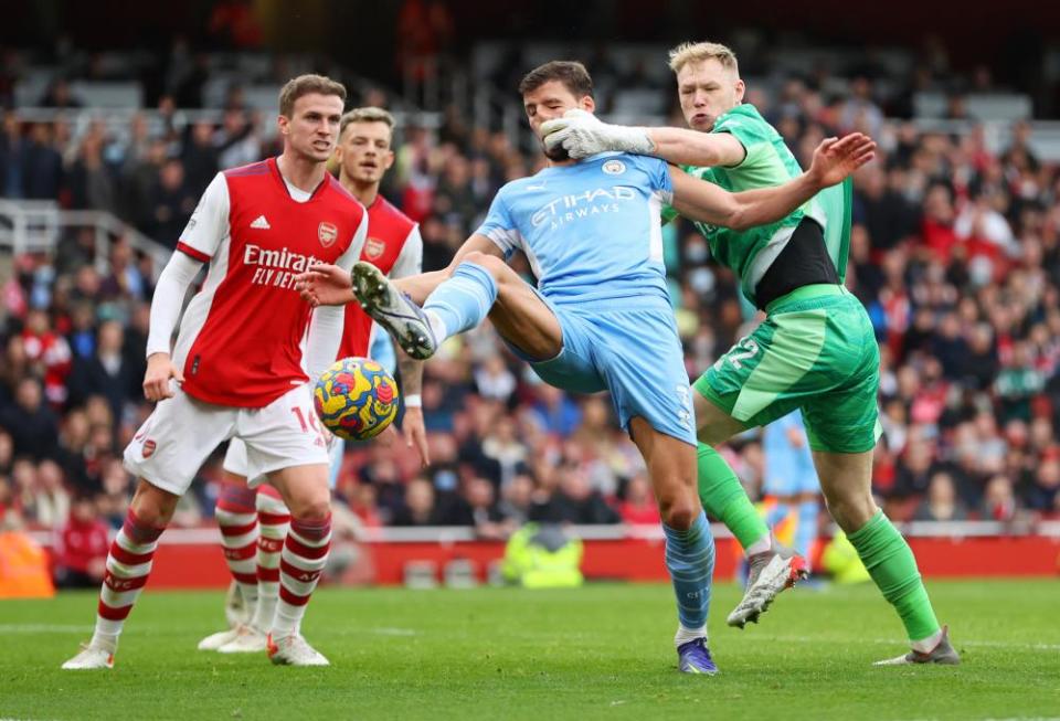 Aaron Ramsdale of Arsenal and Rúben Dias of Manchester City collide on New Year’s Day as City win 2-1 at the Emirates.