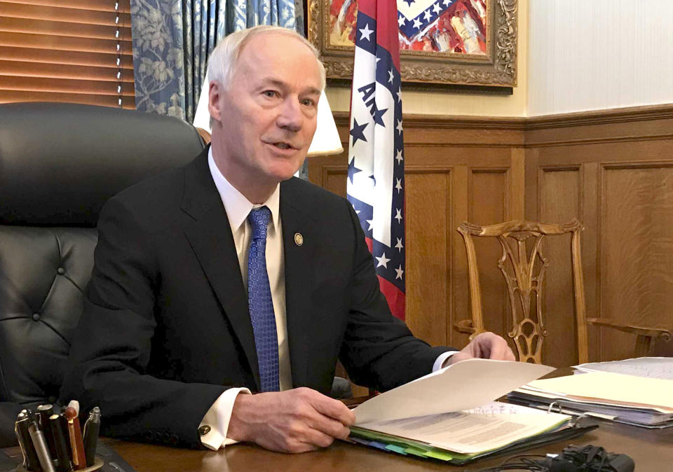 Arkansas Gov. Asa Hutchinson speaks to reporters in his office at the state Capitol in Little Rock, Ark., Wednesday, April 10, 2019, about a bill prohibiting "sanctuary cities" that don't cooperate with federal immigration authorities. The governor said Wednesday he'll sign legislation cutting off funding to "sanctuary cities" that don't cooperate with federal immigration authorities despite the Republican's objections that the measure could open the door to racial profiling. (AP Photo/Andrew DeMillo)