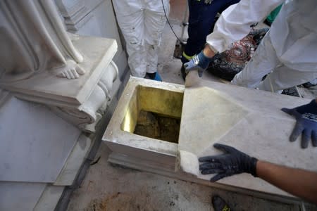People open a tomb in a cemetery on the Vatican's grounds