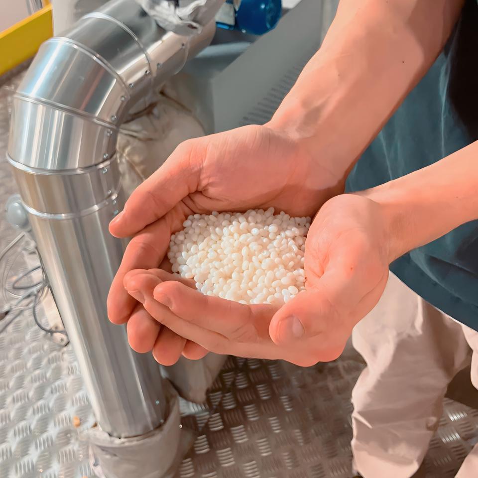 Polymer pellets prior to extrusion and spinning process.