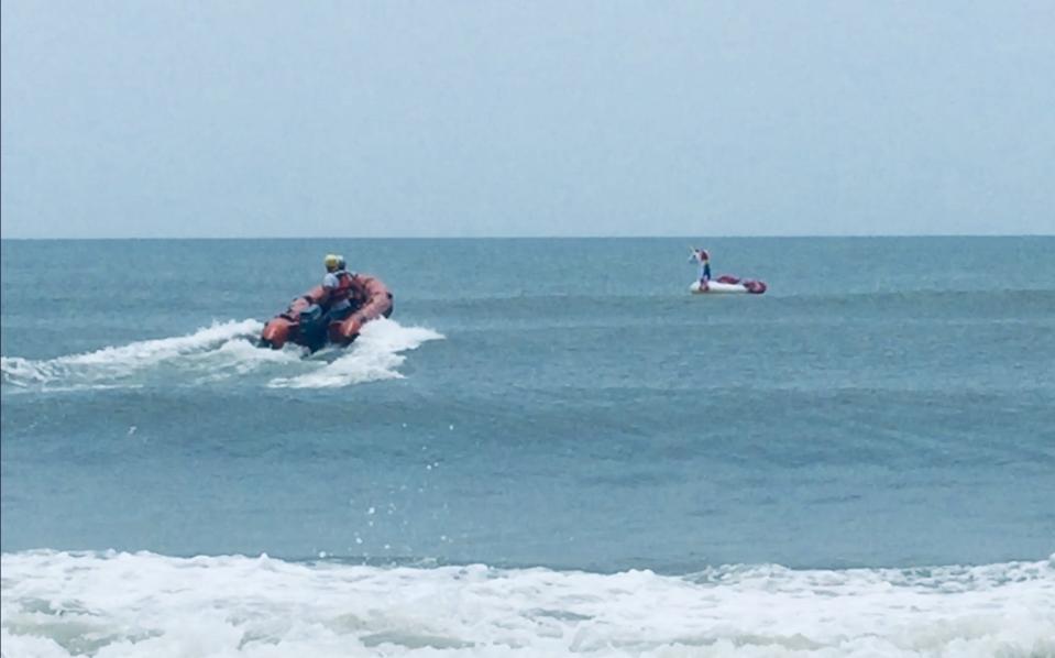 Rescuers at Oak Island, North Carolina, pictured, approaching the boy's inflatable unicorn. Source: Facebook/Oak Island Water Rescue