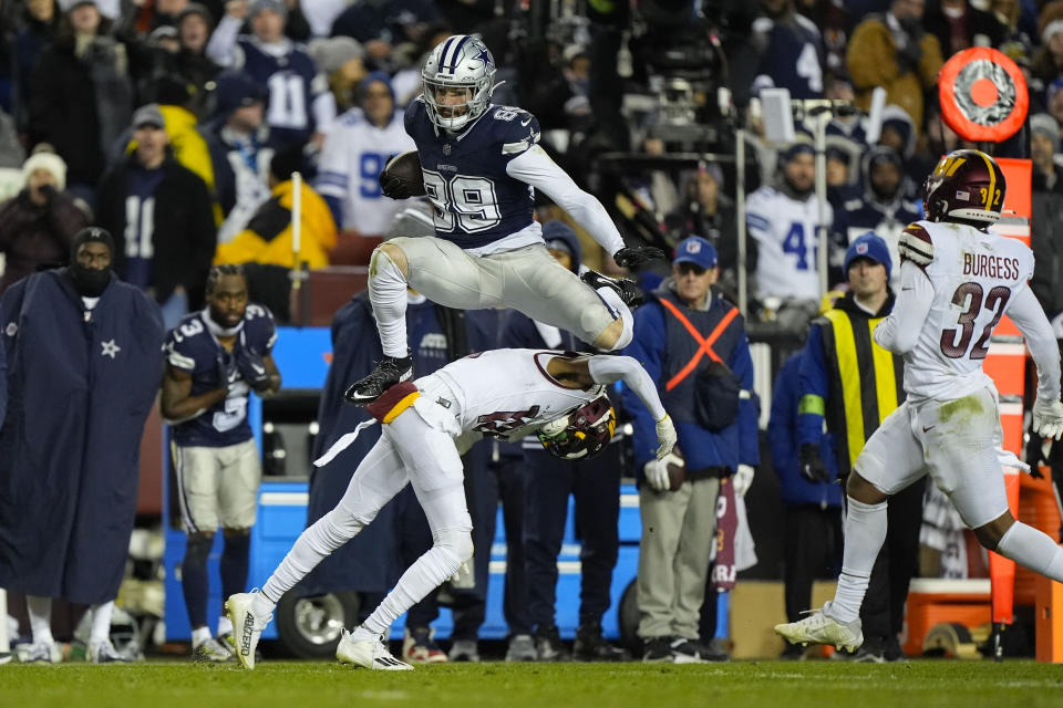 Dallas Cowboys tight end Peyton Hendershot (89) leaping over Washington Commanders cornerback Emmanuel Forbes (13) to avoid the tackle during the second half of an NFL football game, Sunday, Jan. 7, 2024, in Landover, Md. (AP Photo/Mark Schiefelbein)