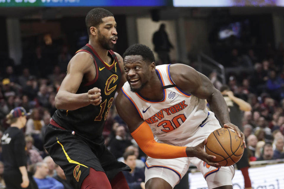 New York Knicks' Julius Randle (30) drives past Cleveland Cavaliers' Tristan Thompson (13) in the second half of an NBA basketball game, Monday, Jan. 20, 2020, in Cleveland. New York won 106-86. (AP Photo/Tony Dejak)
