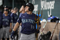 Seattle Mariners' Luis Urias walks through the dugout with a trident after celebrating his two-run home run in the fifth inning of a baseball game against the Texas Rangers in Arlington, Texas, Thursday, April 25, 2024. Dylan Moore also scored on the shot. (AP Photo/Tony Gutierrez)