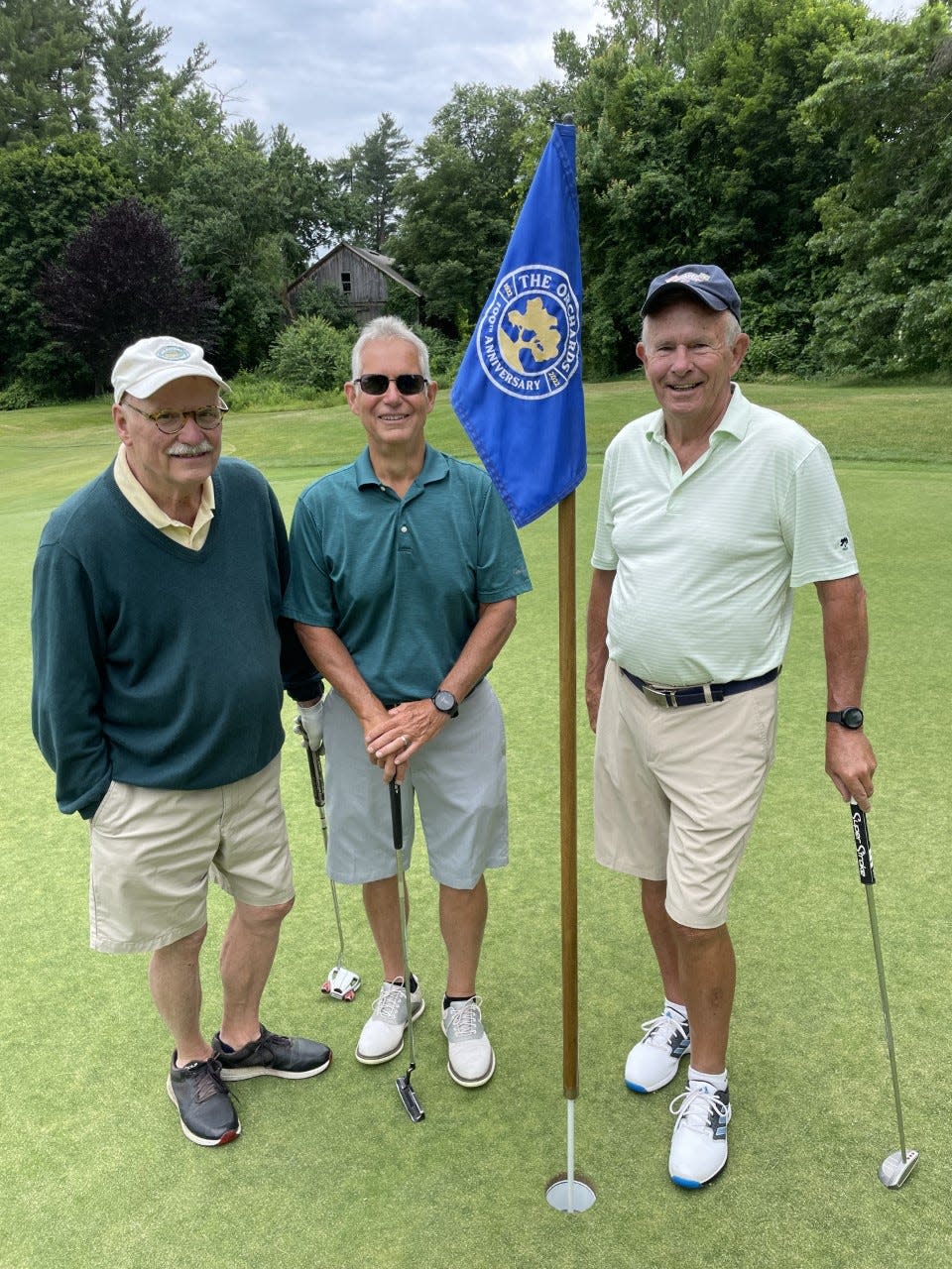 From left, Dr. Bill DuPont, Mark Hobby and Tom Wylie on a green at The Orchards Golf Club.