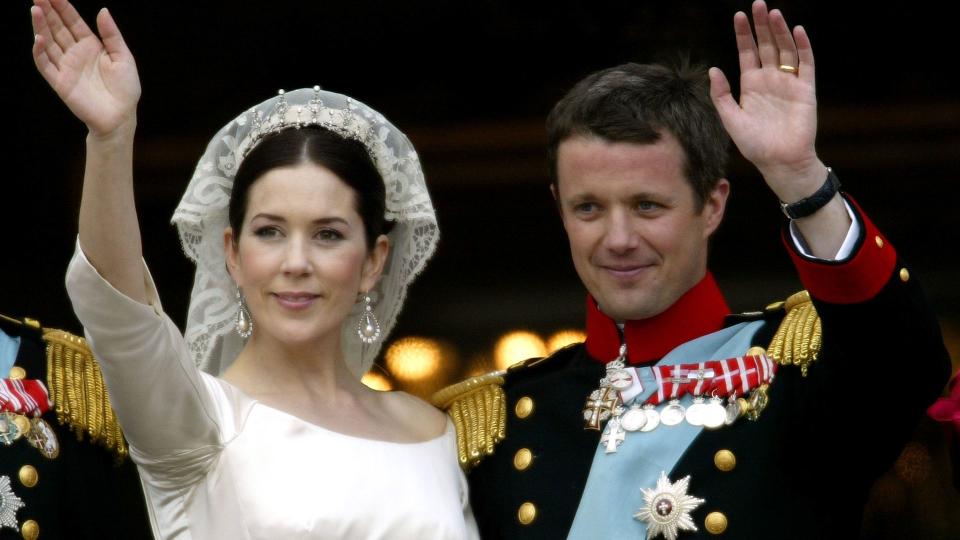 Crown Princess Mary and Crown Prince Frederik of Denmark wave from the balcony of Christian VII's Palace after their wedding on May 14, 2004 