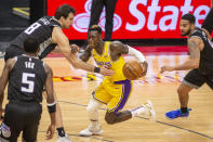 Los Angeles Lakers guard Dennis Schroder (17) drives to the basket as Sacramento Kings forward Nemanja Bjelica (8) reaches for the ball in the second quarter of an NBA basketball game in Sacramento, Calif., Wednesday, March 3, 2021. (AP Photo/Hector Amezcua)