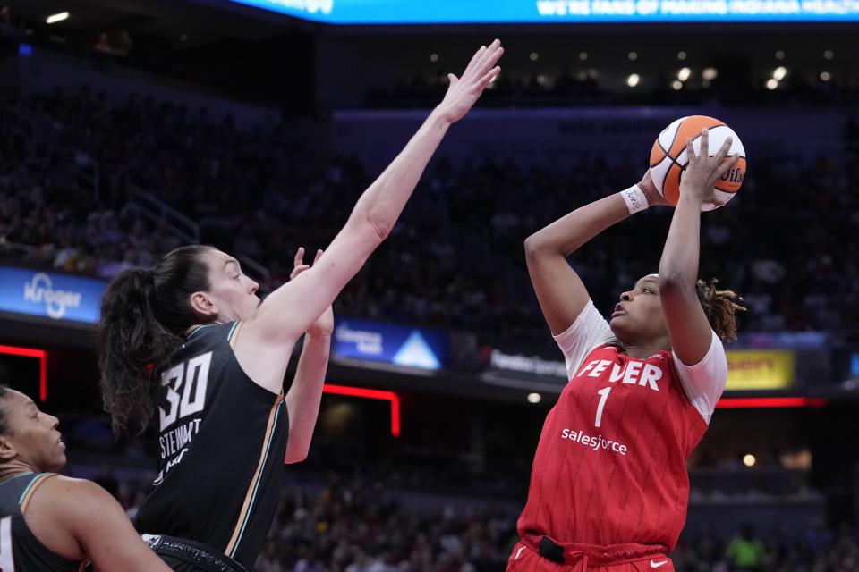 Indiana Fever's NaLyssa Smith (1) shoots over New York Liberty's Breanna Stewart (30) during the second half of a WNBA basketball game, Saturday, July 6, 2024, in Indianapolis. (AP Photo/Darron Cummings)